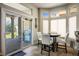 Bright breakfast nook featuring white chairs, a dark table, and a sliding glass door to the patio at 10301 Bent Brook Pl, Las Vegas, NV 89134