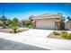 Charming single-story home featuring a spacious driveway, a tile roof, and desert landscaping at 10301 Bent Brook Pl, Las Vegas, NV 89134