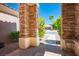 Inviting covered front porch with decorative columns and views of the landscaped front yard at 10301 Bent Brook Pl, Las Vegas, NV 89134