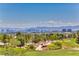 Picturesque view of a lush golf course with city skyline backdrop under a bright blue sky at 10301 Bent Brook Pl, Las Vegas, NV 89134