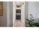 Hallway showing storage area, wood flooring, and décor at 10301 Bent Brook Pl, Las Vegas, NV 89134