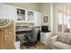 Bright home office with built-in cabinets, desk, chair and sitting area near window at 10301 Bent Brook Pl, Las Vegas, NV 89134