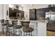Stylish kitchen bar with dark wood cabinets, granite countertops and stainless steel appliances at 10301 Bent Brook Pl, Las Vegas, NV 89134