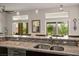 Kitchen bar area with granite countertops, a stainless sink, and natural lighting at 10301 Bent Brook Pl, Las Vegas, NV 89134