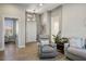 Inviting living room showcasing a comfortable gray armchair and stylish decor at 10301 Bent Brook Pl, Las Vegas, NV 89134