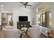Bright living room features comfortable seating, a large window, and a decorative media center at 10301 Bent Brook Pl, Las Vegas, NV 89134