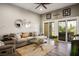 Cozy living room with comfortable sofa, stylish decor, and sliding door access to the patio at 10301 Bent Brook Pl, Las Vegas, NV 89134