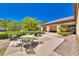 Inviting outdoor patio with comfortable seating area and lush landscaping, perfect for relaxing and enjoying the sunshine at 10301 Bent Brook Pl, Las Vegas, NV 89134