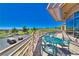 Scenic outdoor patio area with tables, chairs, and views of a lush green golf course under a clear blue sky at 10301 Bent Brook Pl, Las Vegas, NV 89134