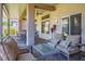 Covered patio features comfortable seating, ceiling fan, and elegant decor for relaxing outdoor enjoyment at 10301 Bent Brook Pl, Las Vegas, NV 89134