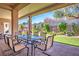 Outdoor patio with table and chairs overlooking the backyard at 10301 Bent Brook Pl, Las Vegas, NV 89134
