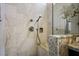 Elegant shower with marble-look tile, built in seat and shower head at 10301 Bent Brook Pl, Las Vegas, NV 89134