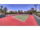 Well-maintained community tennis courts on a sunny day, surrounded by trees and fencing at 10301 Bent Brook Pl, Las Vegas, NV 89134