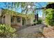 Charming covered back porch with wrought iron fence and a serene view of the desert landscaping at 10302 Cara Mia Ct, Las Vegas, NV 89135