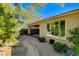 Backyard featuring mature landscaping, gravel walkways, and a covered patio, creating an inviting outdoor living space at 10302 Cara Mia Ct, Las Vegas, NV 89135