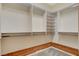 Spacious walk-in closet with custom shelving, wood trim, and carpet flooring at 10302 Cara Mia Ct, Las Vegas, NV 89135