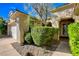 Charming home exterior with desert landscaping, arched entry, and attached garage at 10302 Cara Mia Ct, Las Vegas, NV 89135