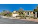 Single-story home shows an attached garage and charming desert landscaping, with easy street access on a sunny day at 10302 Cara Mia Ct, Las Vegas, NV 89135