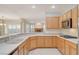 Modern kitchen with tile floors, solid surface countertops, and sleek built-in microwave at 10302 Cara Mia Ct, Las Vegas, NV 89135