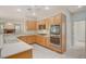 Well-lit kitchen featuring stainless steel appliances, light wood cabinetry, and a double sink at 10302 Cara Mia Ct, Las Vegas, NV 89135