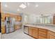 Well-lit kitchen featuring stainless steel appliances, natural wood cabinets, and a skylight at 10302 Cara Mia Ct, Las Vegas, NV 89135
