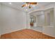 Well-lit room with wood floors, decorative columns, and an archway creating an open space at 10302 Cara Mia Ct, Las Vegas, NV 89135