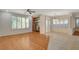 Bright and airy living room with built-in shelves, shutters, and wood and tile floors at 10302 Cara Mia Ct, Las Vegas, NV 89135