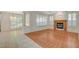 Spacious living room with wood and tile flooring, fireplace, and large windows with shutters at 10302 Cara Mia Ct, Las Vegas, NV 89135