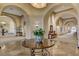 Elegant lobby featuring arched walkways, decorative plants, and stylish decor at 10302 Cara Mia Ct, Las Vegas, NV 89135
