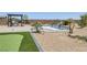 Inviting backyard featuring a putting green, barbecue, spa, and desert landscaping at 11088 Westcroft Way, Las Vegas, NV 89183