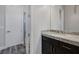 Contemporary bathroom featuring a granite countertop vanity, sink, and wood-style flooring at 11088 Westcroft Way, Las Vegas, NV 89183