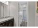 Bathroom featuring a granite countertop vanity and sink, with a view into an adjacent bedroom at 11088 Westcroft Way, Las Vegas, NV 89183