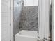 Elegant bathroom showcases a tiled shower with glass doors, featuring granite walls and a rainfall shower head at 11088 Westcroft Way, Las Vegas, NV 89183