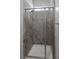 Luxurious bathroom displaying a modern glass enclosed shower with marble-style tiling and white base at 11088 Westcroft Way, Las Vegas, NV 89183