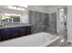 Elegant bathroom showcasing a soaking tub, glass shower, and dual vanities with granite countertops at 11088 Westcroft Way, Las Vegas, NV 89183