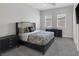 Well-lit bedroom with black furniture set and two windows that let in natural light at 11088 Westcroft Way, Las Vegas, NV 89183