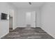 A bright bedroom showcases stylish flooring, a ceiling fan, mounted TV, and a doorway to another room at 11088 Westcroft Way, Las Vegas, NV 89183