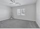 Bright bedroom with carpet flooring, ceiling fan, a window, and neutral decor at 11088 Westcroft Way, Las Vegas, NV 89183