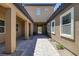 Charming home entrance featuring a gated courtyard, walkway, and stone accents at 11088 Westcroft Way, Las Vegas, NV 89183