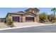 Beautiful two-story home featuring a three-car garage, desert landscaping, and a tile roof at 11088 Westcroft Way, Las Vegas, NV 89183