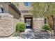 Charming home entrance featuring a gated courtyard and stone accents at 11088 Westcroft Way, Las Vegas, NV 89183