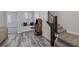 Hallway with wood-style flooring, an arcade game, and a staircase with black wood and steel banister at 11088 Westcroft Way, Las Vegas, NV 89183
