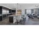 Spacious kitchen featuring dark cabinetry, stainless steel appliances, a center island, and pendant lighting at 11088 Westcroft Way, Las Vegas, NV 89183
