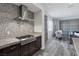 Kitchen features a gas range, mosaic backsplash, granite countertops, and open access to the living area at 11088 Westcroft Way, Las Vegas, NV 89183