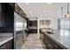 Spacious kitchen featuring stainless steel appliances, dark cabinetry, a large island, and pendant lighting at 11088 Westcroft Way, Las Vegas, NV 89183