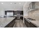 Gourmet kitchen features stainless steel appliances, granite countertops, custom backsplash, and ample cabinet space at 11088 Westcroft Way, Las Vegas, NV 89183