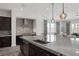 Kitchen features a large island with granite countertops, stainless steel appliances, and dark cabinetry at 11088 Westcroft Way, Las Vegas, NV 89183