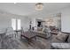 Spacious living room with an open floor plan, wood floors, and stylish furniture at 11088 Westcroft Way, Las Vegas, NV 89183
