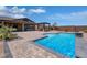 Sparkling pool with stone surround, outdoor kitchen, and covered patio, perfect for entertaining at 11088 Westcroft Way, Las Vegas, NV 89183