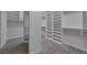 Spacious walk-in closet with built-in white shelving and ample storage, featuring carpet flooring at 11088 Westcroft Way, Las Vegas, NV 89183